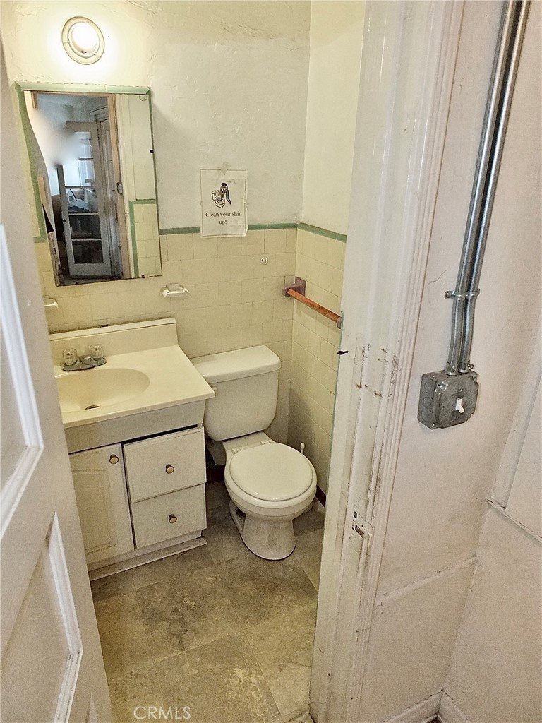 836 Atlantic Avenue Long Beach, CA 90813 - Photo 23 of 27 a bathroom with a toilet sink and mirror
