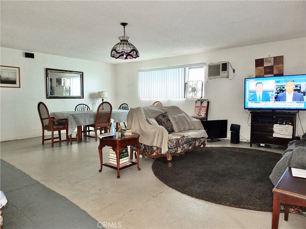 836 Atlantic Avenue Long Beach, CA 90813 - Photo 8 of 27 a living room with furniture a flat screen tv and a fireplace