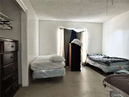 a bedroom with bed and window