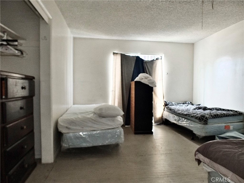 836 Atlantic Avenue Long Beach, CA 90813 - Photo 9 of 27 a bedroom with bed and window