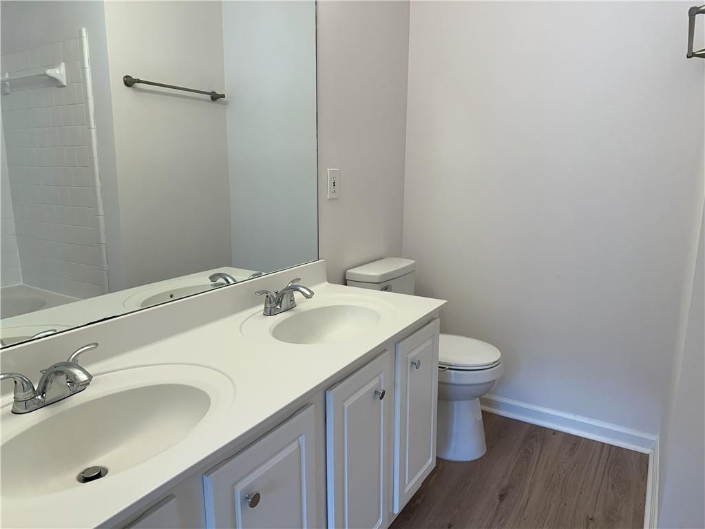 4162 Howell Park Road Duluth, GA 30096 - Photo 11 of 16 a bathroom with a sink toilet and mirror