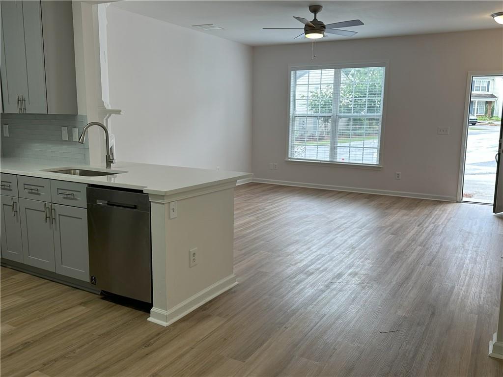 4162 Howell Park Road Duluth, GA 30096 - Photo 15 of 16 a kitchen with a sink cabinets stainless steel appliances and a window