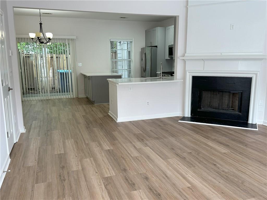 4162 Howell Park Road Duluth, GA 30096 - Photo 16 of 16 a view of a kitchen with a sink and a fireplace