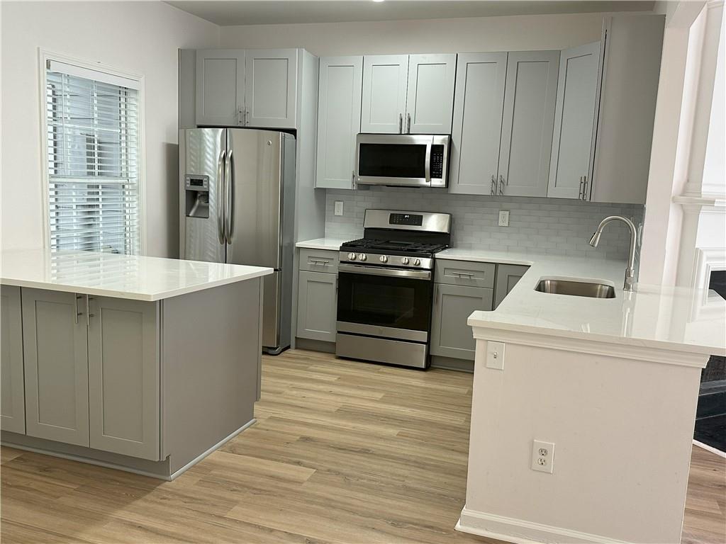 4162 Howell Park Road Duluth, GA 30096 - Photo 4 of 16 a kitchen with a stove a refrigerator and a sink