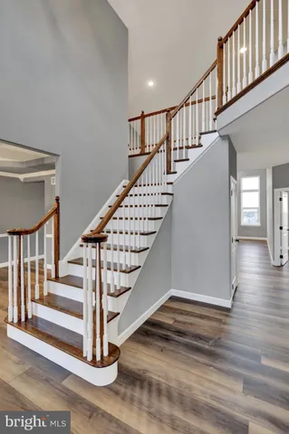 a view of entryway and hall with wooden floor