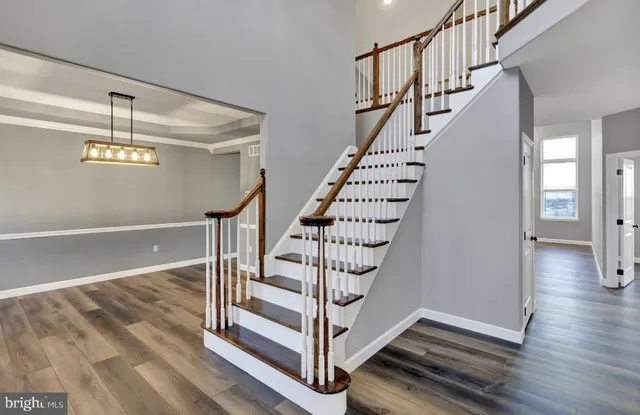 a view of entryway and hall with wooden floor