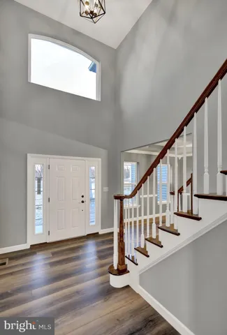a view of entryway and hall with wooden floor