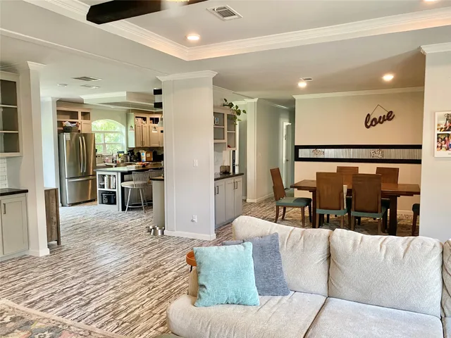 a living room with furniture and kitchen view