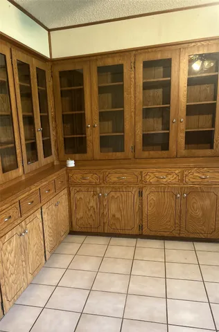 a view of a utility room with cabinets