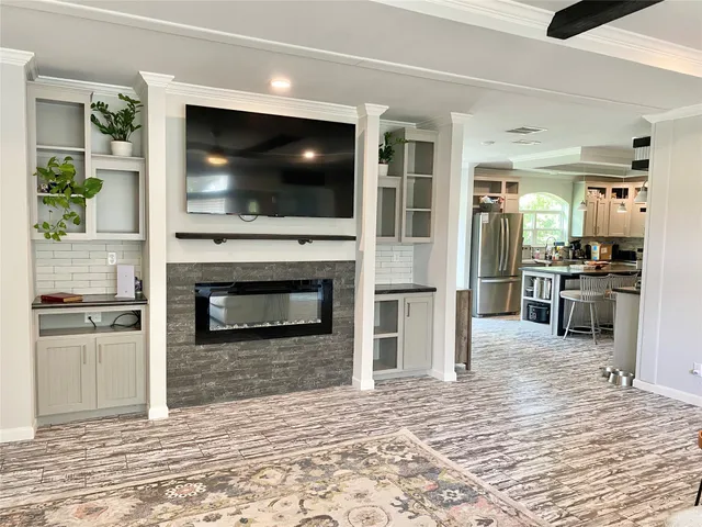 a view of living room kitchen with stainless steel appliances kitchen stove and living room