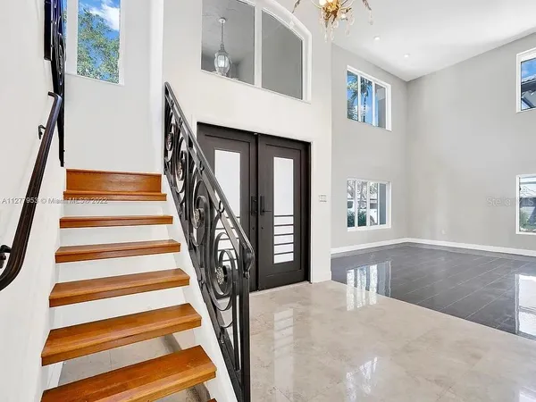 a view of entryway and hall with wooden floor