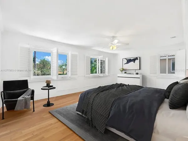a bed room with a bed and a chandelier