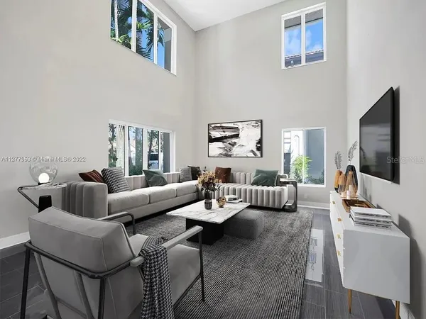 a living room with furniture and a flat screen tv