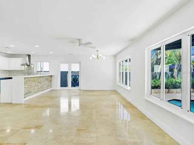 a view of an empty room with a kitchen stove back oven