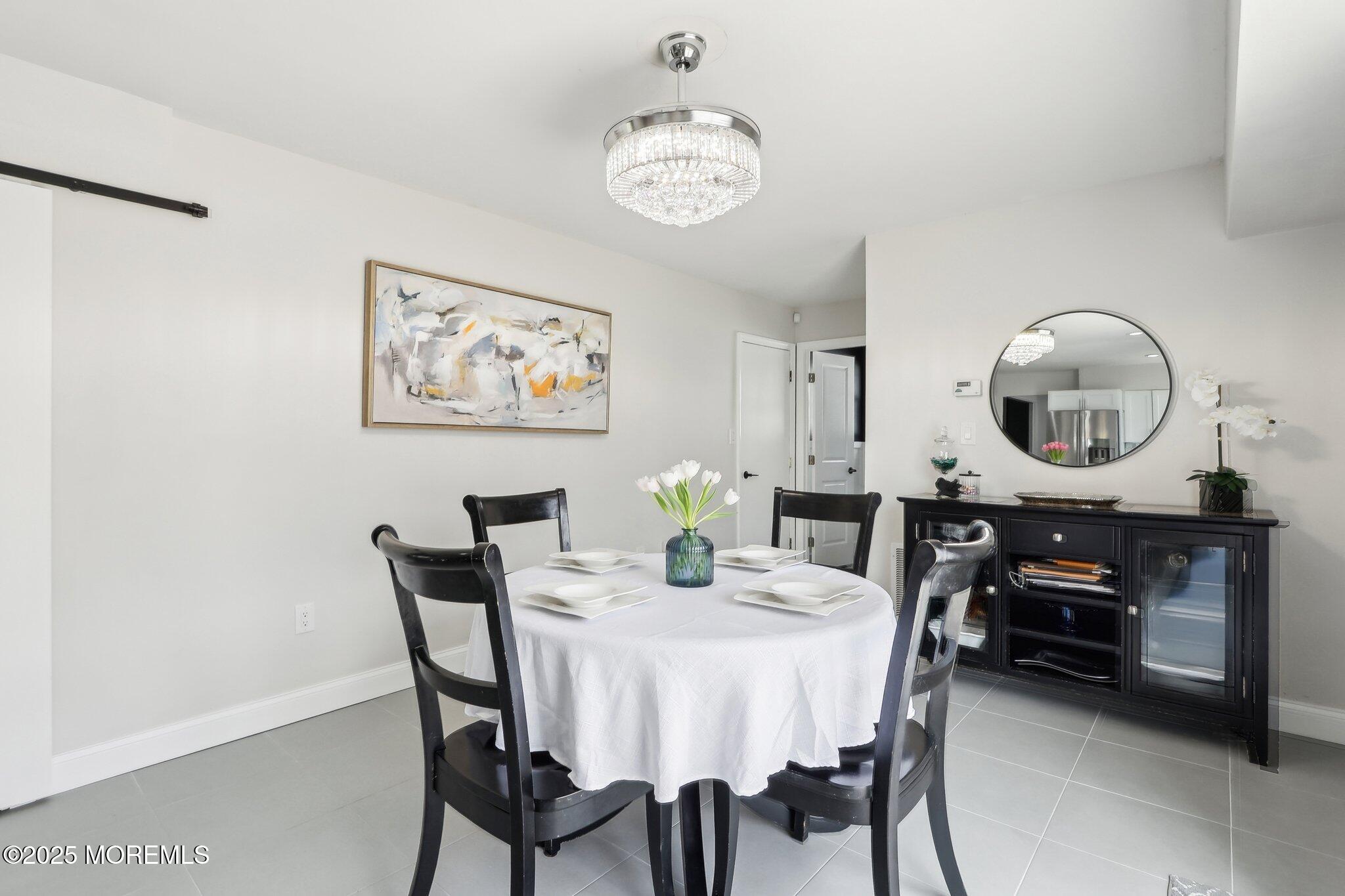 572 Line Road Hazlet, NJ 07730 - Photo 13 of 39 a view of a dining room with furniture and a mirror
