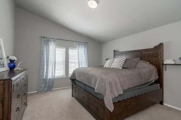 a spacious bedroom with a bed and a window