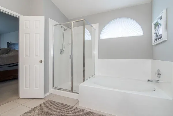 a bathroom with a tub shower and sink