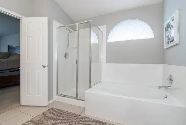 a bathroom with a tub shower and sink