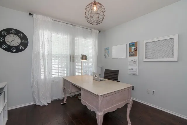 a view of a room with a table and chairs