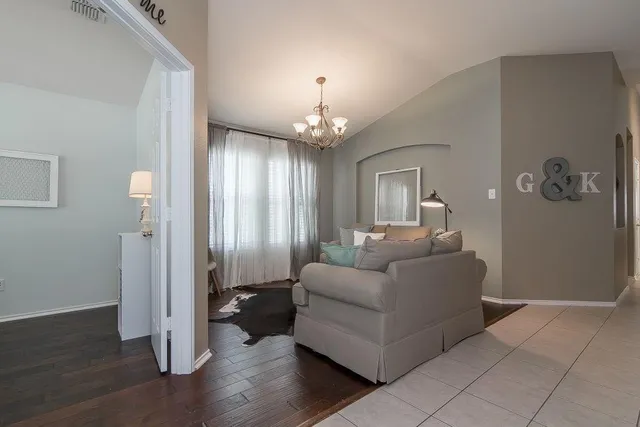 a living room with furniture and a chandelier