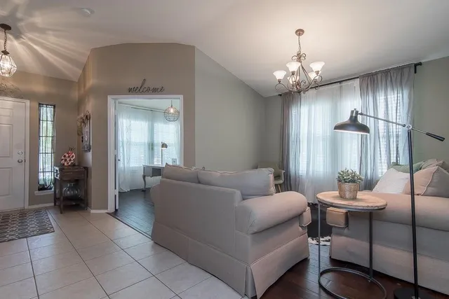 a living room with furniture and a chandelier