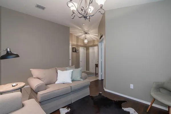 a living room with furniture a chandelier and a couch