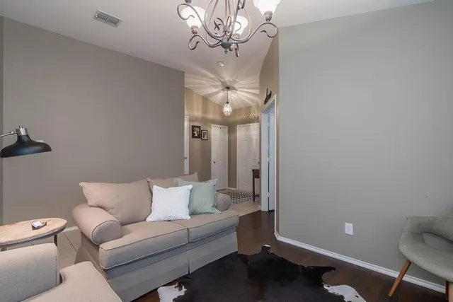 a living room with furniture a chandelier and a couch