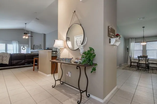 a living room with furniture a table and chairs