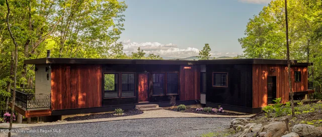 a view of a house with swimming pool and sitting area