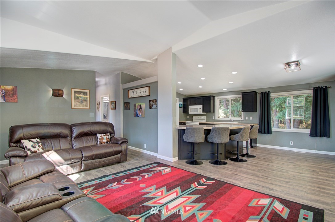 595 Nevil Road Winlock, WA 98596 - Photo 12 of 34 a living room with furniture a rug and kitchen view