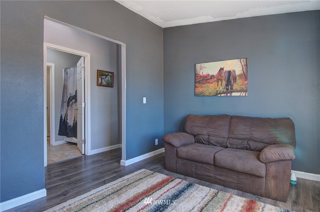 595 Nevil Road Winlock, WA 98596 - Photo 13 of 34 a living room with furniture and a wooden floor