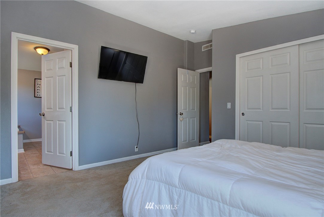 595 Nevil Road Winlock, WA 98596 - Photo 17 of 34 a bedroom with a bed and a flat screen tv
