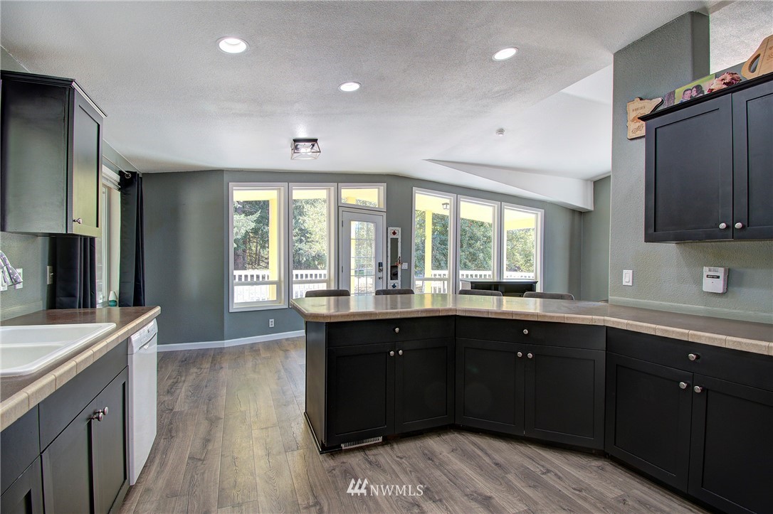 595 Nevil Road Winlock, WA 98596 - Photo 7 of 34 a large kitchen with stainless steel appliances granite countertop a sink and wooden cabinets