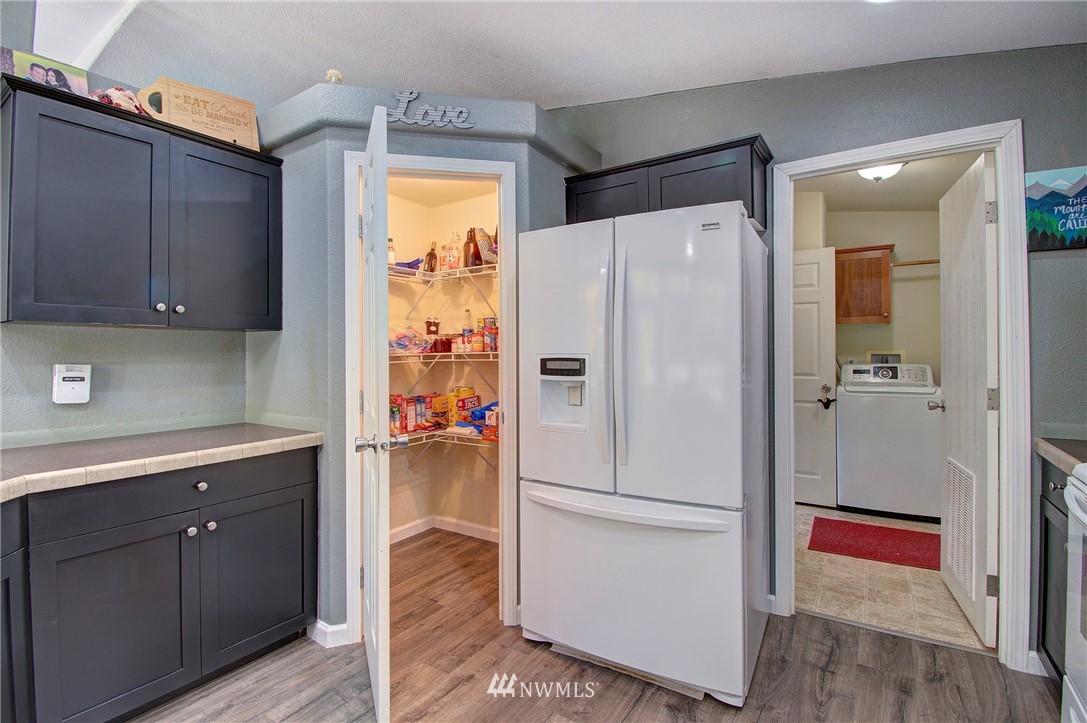 595 Nevil Road Winlock, WA 98596 - Photo 10 of 34 a white refrigerator freezer sitting in a kitchen