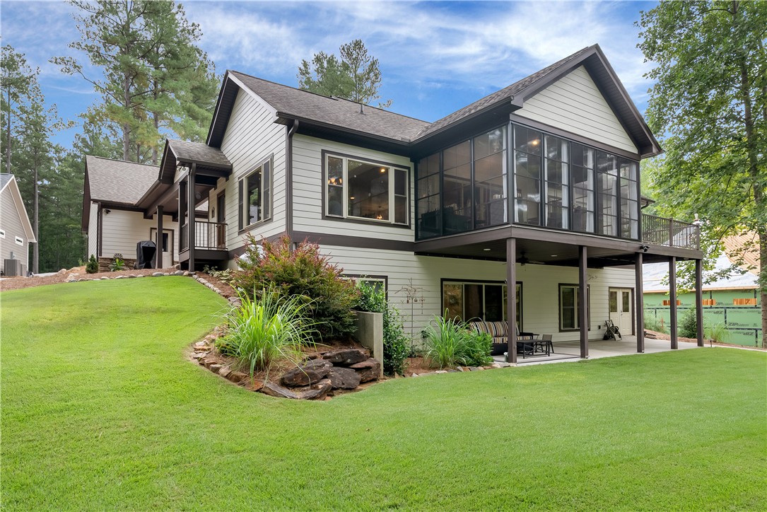329 High Hampton Road Salem, SC 29676 - Photo 3 of 47 An elevated screened porch overlooks a rolling green lawn bordered by mature trees.