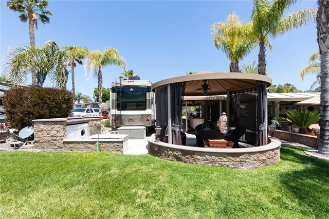 a view of a chair and table in backyard of the house