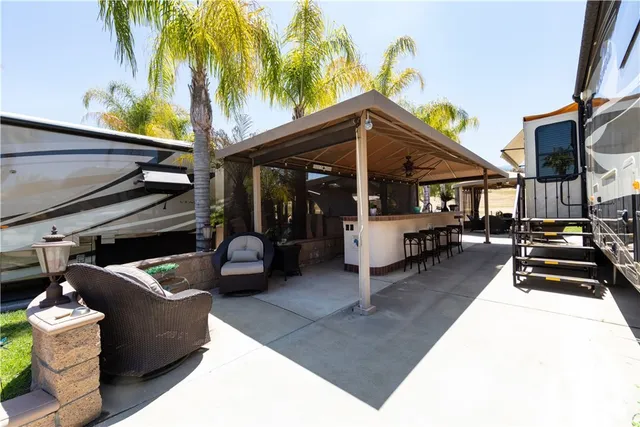 a view of a patio with table and chairs potted plants