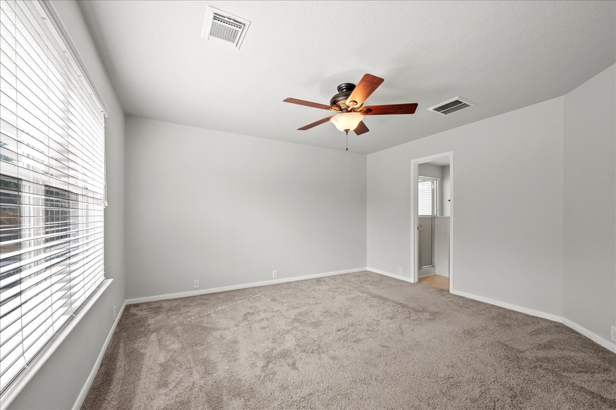 17535 Prospect Meadows Drive Houston, TX 77095 - Photo 17 of 39 The primary bedroom exudes a tranquil elegance with soft muted colors adorning the walls, complemented by plush carpeting.