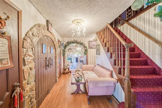 a view of a dining room with furniture and chandelier