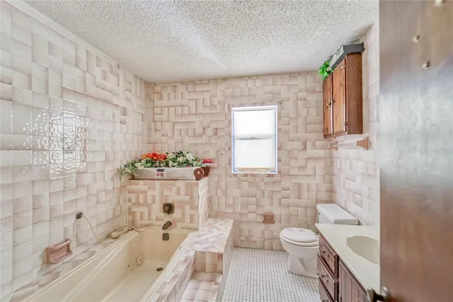 an aerial view of residential houses with outdoor space and trees