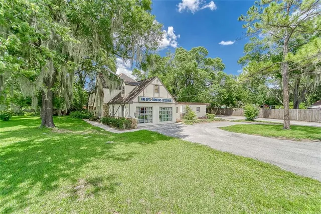 a front view of a house with yard and green space