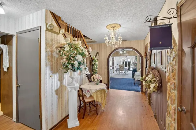 a view of entryway livingroom and hall with wooden floor