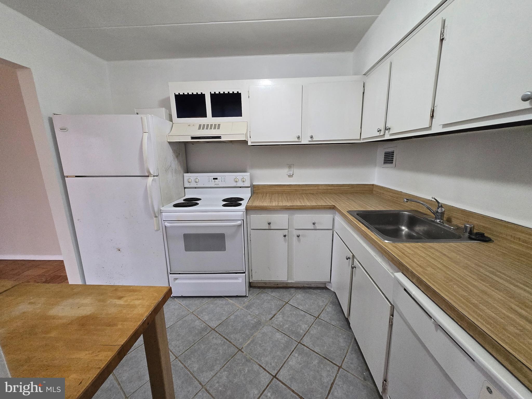 2614 Fort Farnsworth Road, Unit 254 Alexandria, VA 22303 - Photo 2 of 11 a kitchen with a stove top oven and cabinets