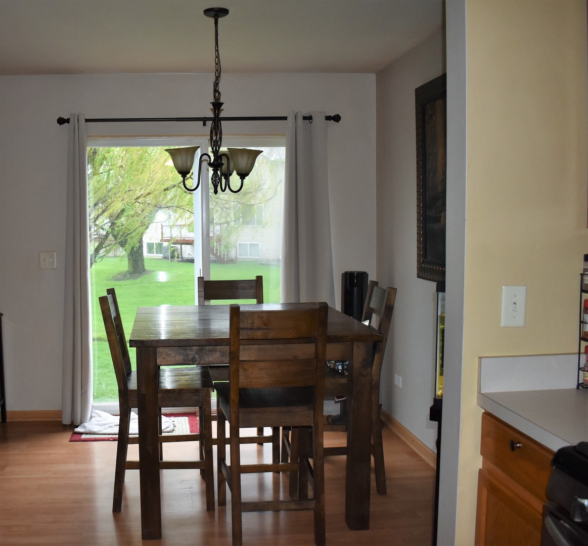 605 Chestnut Ridge Minooka, IL 60447 - Photo 6 of 16 a dining room with furniture window and wooden floor