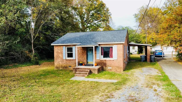 a house view with swimming pool in front of it