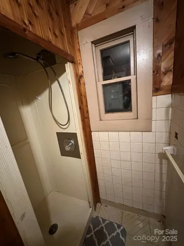 a bathroom with a sink and glass door shower