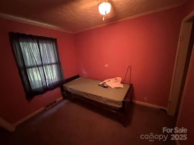 a room with pool table and windows