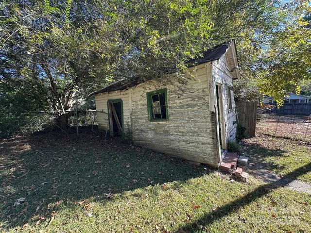 a backyard of a house with barbeque oven