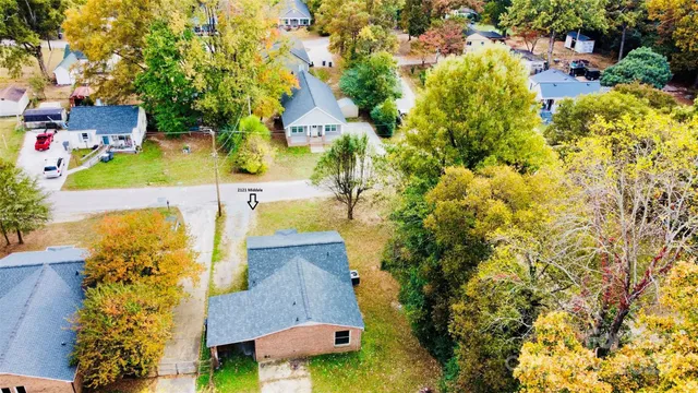 an aerial view of residential houses with yard