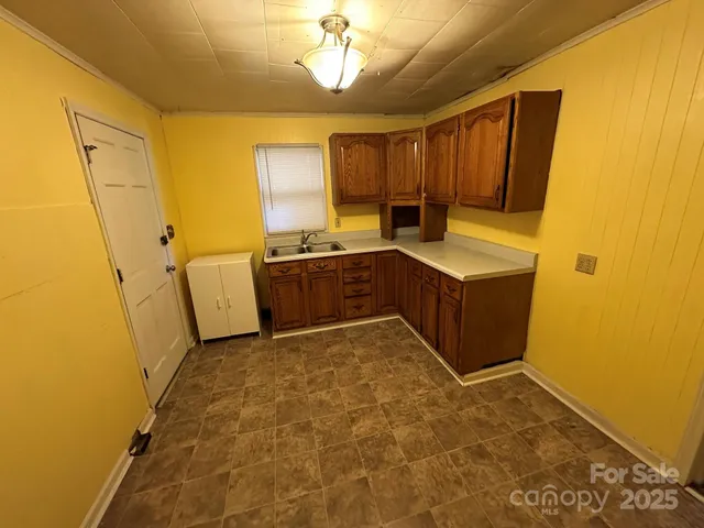 a kitchen with stainless steel appliances a stove a sink and a refrigerator